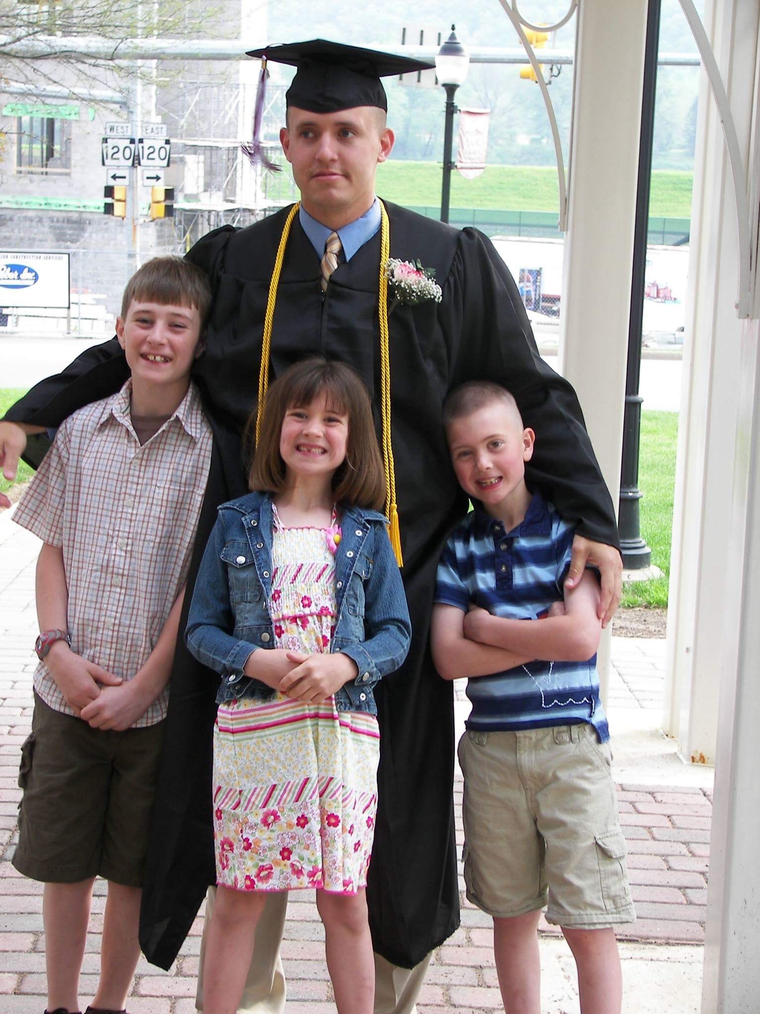 SSG Leek with his three children at his graduation